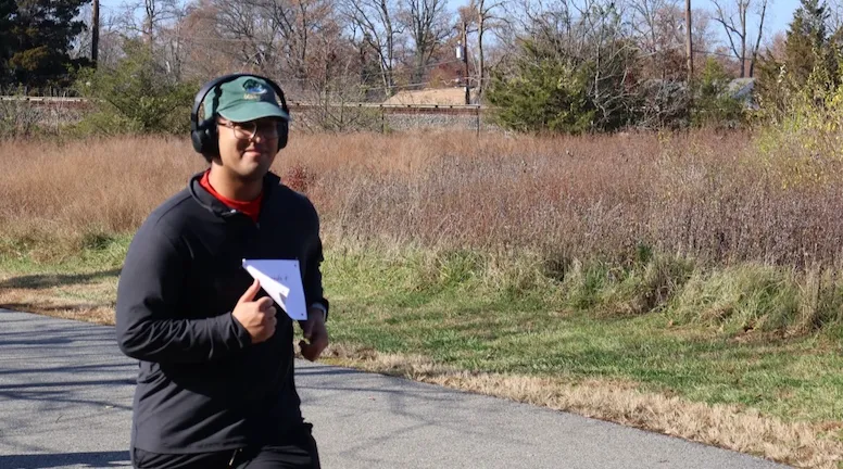 A participant running on the paved course at Lake Artemesia.